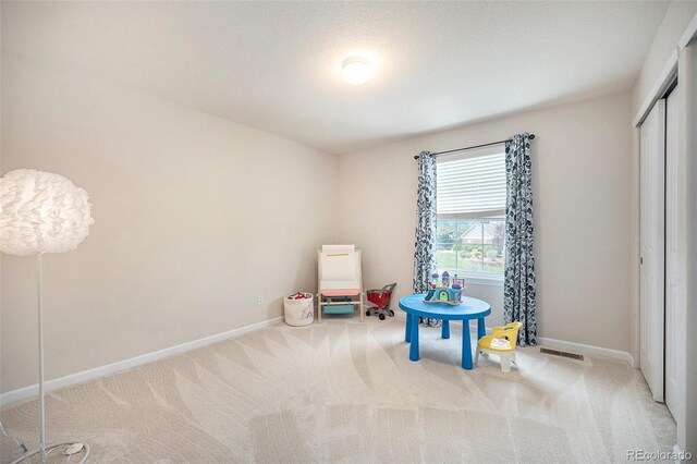 game room featuring carpet flooring and baseboards