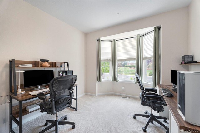 carpeted office featuring baseboards