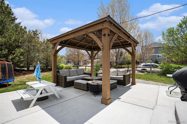 view of patio / terrace with outdoor lounge area, a trampoline, and a gazebo