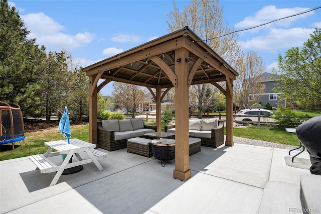 6092 S Ouray St, Aurora, CO 80016 - view of patio with an outdoor hangout area, a trampoline, and a gazebo