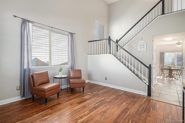 10359 Tracewood Dr, Highlands Ranch, CO 80130 - living area featuring wood finished floors, stairway, baseboards, a ceiling fan, and a towering ceiling
