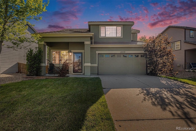 10359 Tracewood Dr, Highlands Ranch, CO 80130 - view of front facade featuring concrete driveway, stucco siding, an attached garage, a yard, and a tiled roof