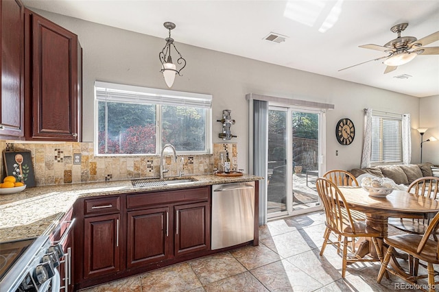 10359 Tracewood Dr, Highlands Ranch, CO 80130 - kitchen featuring appliances with stainless steel finishes, a sink, decorative backsplash, ceiling fan, and hanging light fixtures