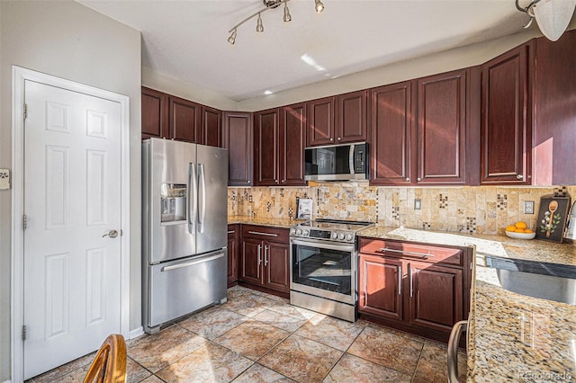 10359 Tracewood Dr, Highlands Ranch, CO 80130 - kitchen with stainless steel appliances, decorative backsplash, a sink, and reddish brown cabinets
