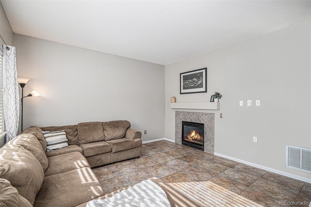 10359 Tracewood Dr, Highlands Ranch, CO 80130 - living area featuring a tiled fireplace, baseboards, and stone finish floors
