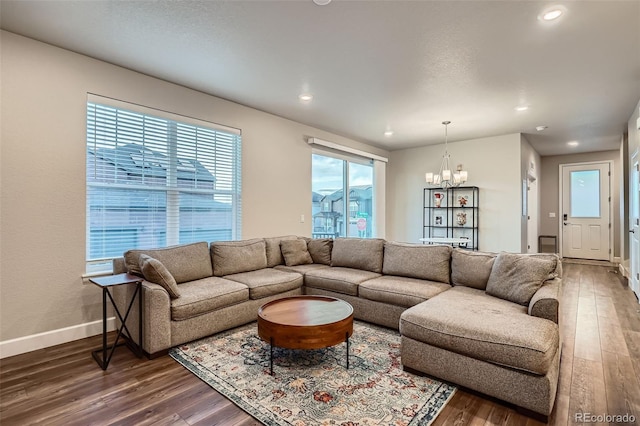 living area with a chandelier, dark wood finished floors, baseboards, and recessed lighting