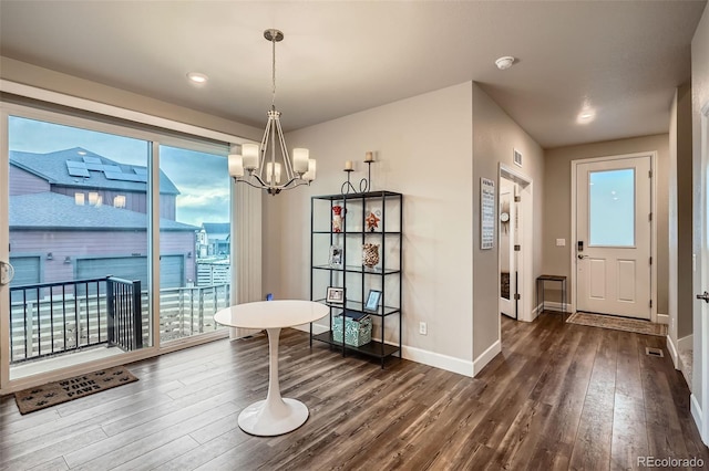 dining area with dark wood-type flooring, baseboards, a chandelier, and recessed lighting
