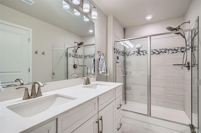 full bathroom featuring a stall shower, double vanity, and recessed lighting