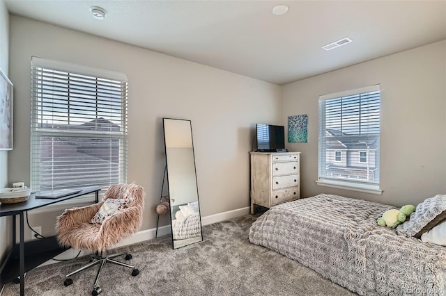 bedroom with carpet floors and baseboards