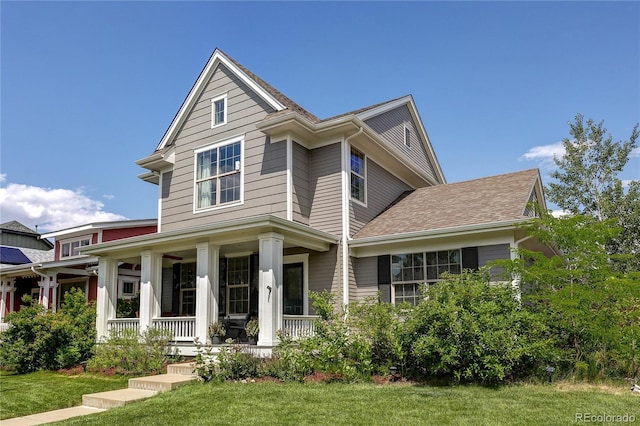 3354 Wabash St, Denver, CO 80238 - view of front of home featuring covered porch and a front yard