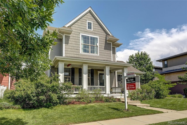 3354 Wabash St, Denver, CO 80238 - view of front of home with covered porch and a front lawn