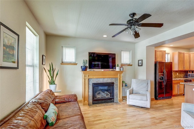 3354 Wabash St, Denver, CO 80238 - living area featuring plenty of natural light, light wood-style floors, a fireplace, ceiling fan, and recessed lighting
