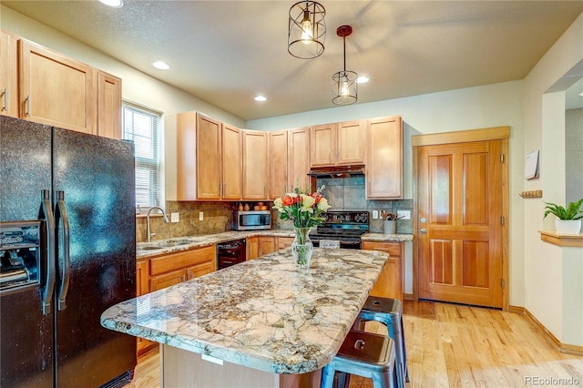 3354 Wabash St, Denver, CO 80238 - kitchen with black appliances, light wood-type flooring, under cabinet range hood, backsplash, and recessed lighting