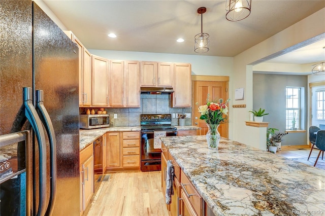 3354 Wabash St, Denver, CO 80238 - kitchen featuring black appliances, under cabinet range hood, light wood finished floors, tasteful backsplash, and light stone countertops