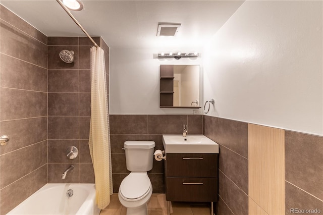830 N Sherman St Unit 105, Denver, CO 80203 - full bath with tile walls, vanity, shower / bathtub combination with curtain, a wainscoted wall, and tile patterned flooring