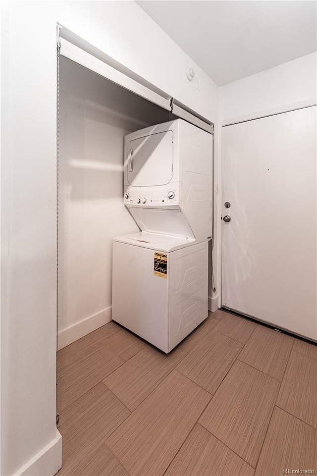 830 N Sherman St Unit 105, Denver, CO 80203 - laundry area featuring stacked washer / drying machine and wood finish floors