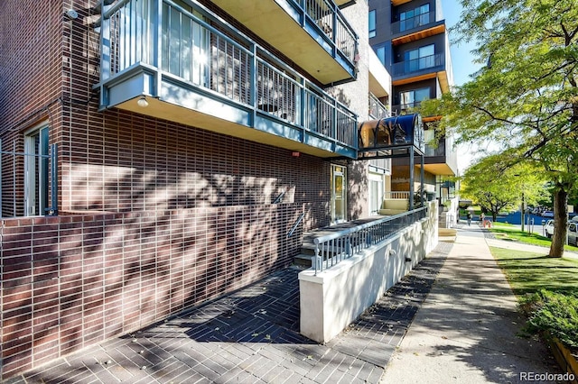 830 N Sherman St Unit 105, Denver, CO 80203 - view of side of property featuring a balcony and brick siding