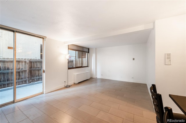 830 N Sherman St Unit 105, Denver, CO 80203 - empty room featuring baseboards and radiator heating unit