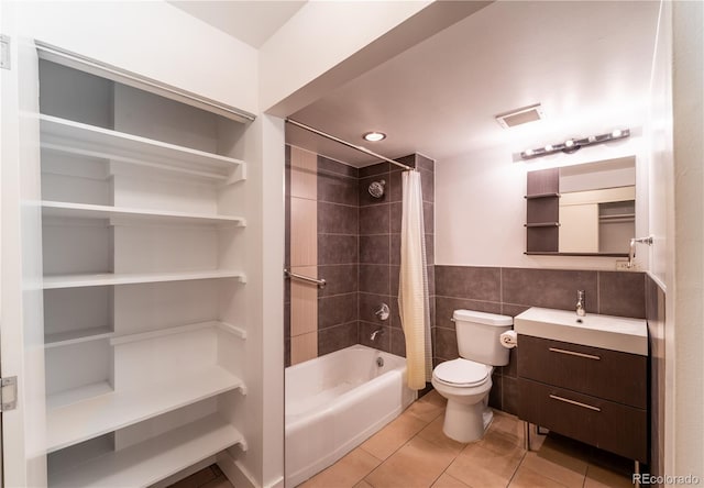830 N Sherman St Unit 105, Denver, CO 80203 - bathroom featuring vanity, shower / bathtub combination with curtain, tile patterned flooring, and tile walls