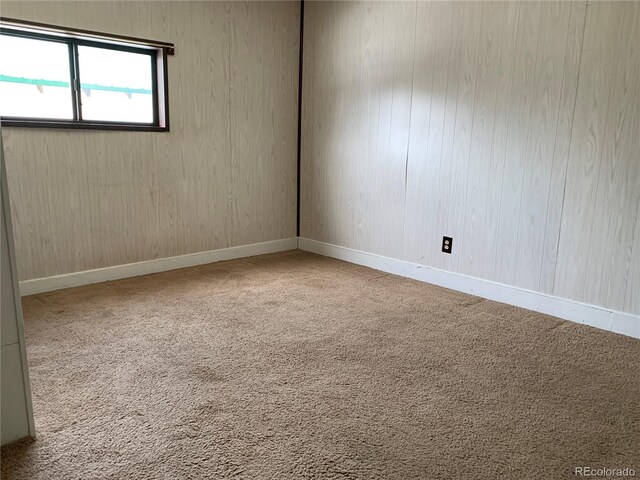 empty room with baseboards and carpet floors