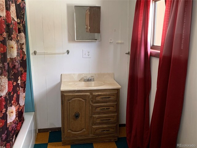 full bathroom featuring vanity and shower / bath combo with shower curtain