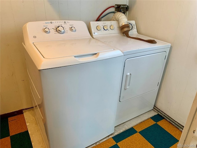 washroom with separate washer and dryer and light floors