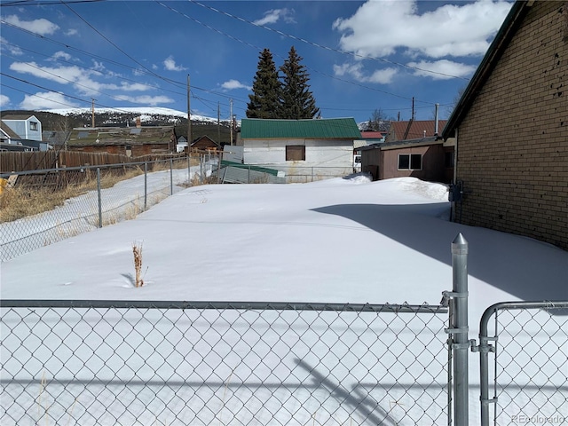 yard covered in snow with fence