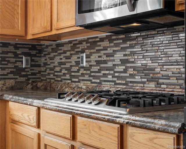 details featuring stainless steel appliances and decorative backsplash