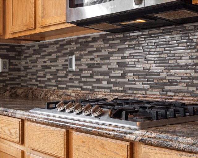 details with tasteful backsplash and stainless steel appliances