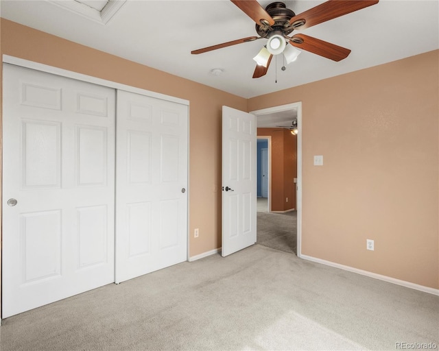 unfurnished bedroom with light colored carpet, a closet, ceiling fan, and baseboards