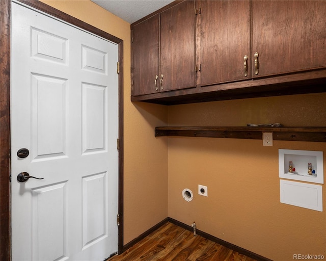 clothes washing area with dark wood finished floors, hookup for an electric dryer, baseboards, cabinet space, and hookup for a washing machine