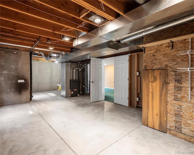 unfinished basement featuring heating unit