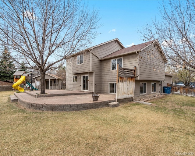 back of property with a playground, a yard, fence, and a patio