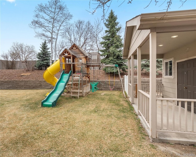 view of jungle gym featuring a lawn and fence