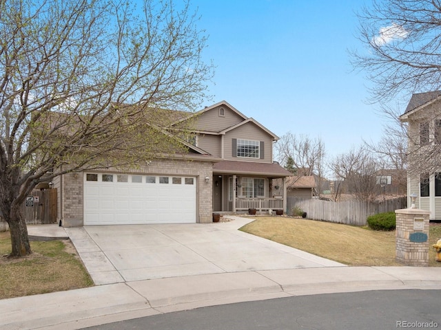 traditional-style home with driveway, covered porch, fence, and a front yard