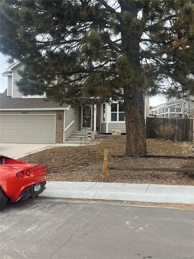 obstructed view of property with a garage