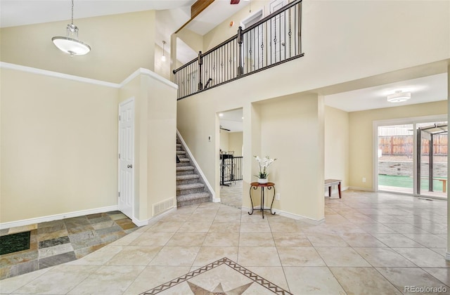 interior space featuring a towering ceiling and tile patterned floors