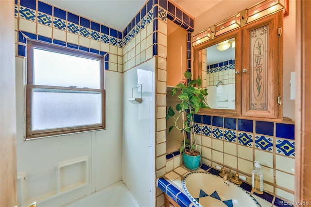 bathroom with vanity and tile walls