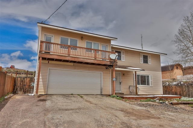 front facade featuring a garage and a balcony