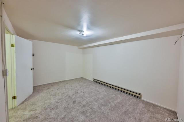 carpeted spare room with baseboard heating