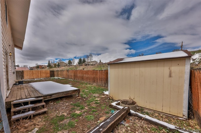 view of yard with a shed and a wooden deck