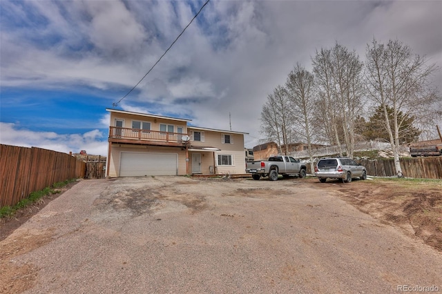 view of front of house with a garage and a balcony