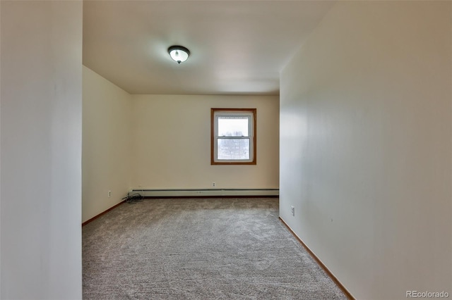 unfurnished room with a baseboard radiator and carpet floors