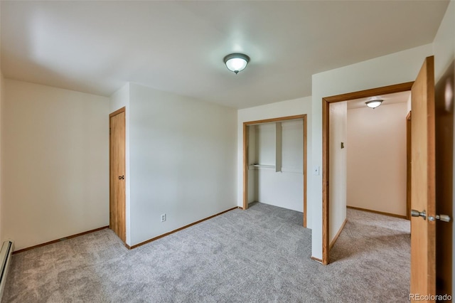 unfurnished bedroom with light carpet, a baseboard radiator, and a closet