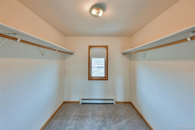 spacious closet featuring baseboard heating and carpet