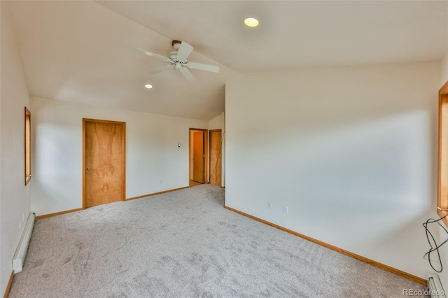 unfurnished room featuring carpet flooring, vaulted ceiling, a baseboard radiator, and ceiling fan