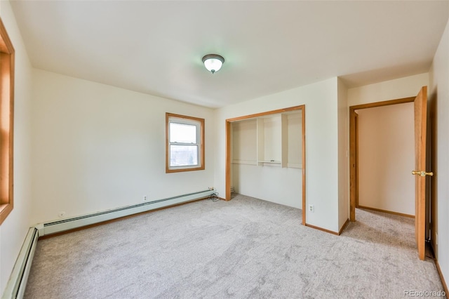 unfurnished bedroom featuring carpet, a baseboard radiator, and a closet