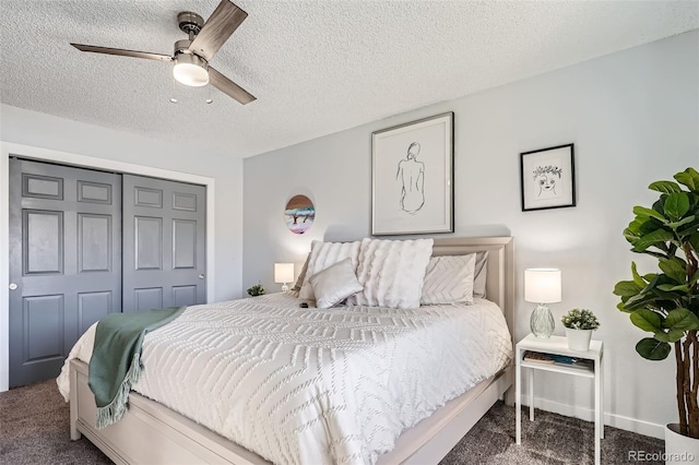 bedroom featuring dark colored carpet, ceiling fan, a textured ceiling, and a closet