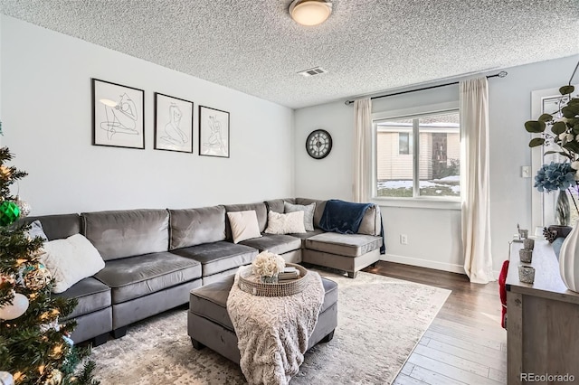 living room with dark wood-type flooring and a textured ceiling