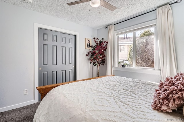 carpeted bedroom featuring a textured ceiling, a closet, and ceiling fan